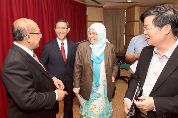 Raring to start: Patahiyah sharing a light moment with Deputy Chief Minister I Datuk Mohd Rashid Hasnon (centre) and State Financial Officer Datuk Mokhtar Jait after the press conference in Komtar, Penang.